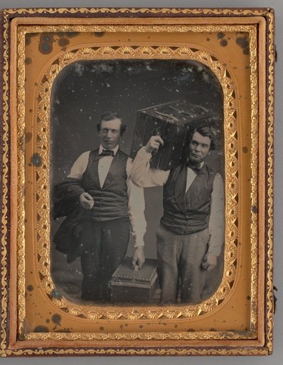 Untitled (Portrait of Two Standing Men Carrying Trunks)
