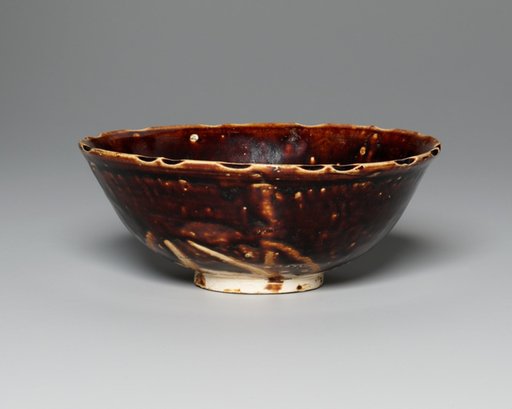 Stoneware with Mold Impressed Design and Dark Brown Glaze