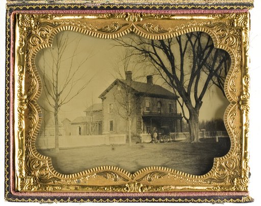 Two and a Half Story Brick Country House with Outbuildings with Ornate Porch and Picket Fence
