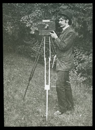 Self-Portrait with camera, tripod and pistol