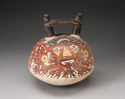 Doubnle Spout Vessel Depicing Ornametal Faces with Numerous Emanations
