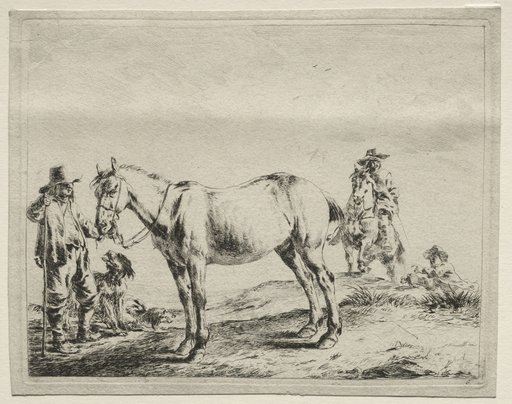 Man holding a horse by the bridle