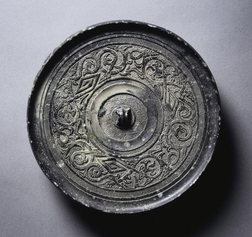 Mirror with Serpentine Interlaces and Angular Meanders