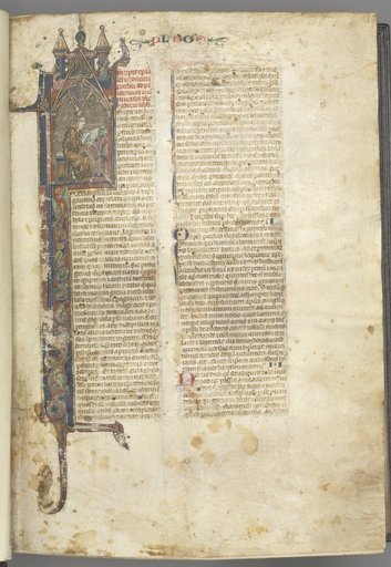 Fol. ir: Prologue, St. Jerome, large historiated initial I, the saint in a brown habit writing at a desk in a gothic architectural frame, with full-length border of foliage and small hybrids, a hare, a dog and a grotesque perched on the foliage extensions