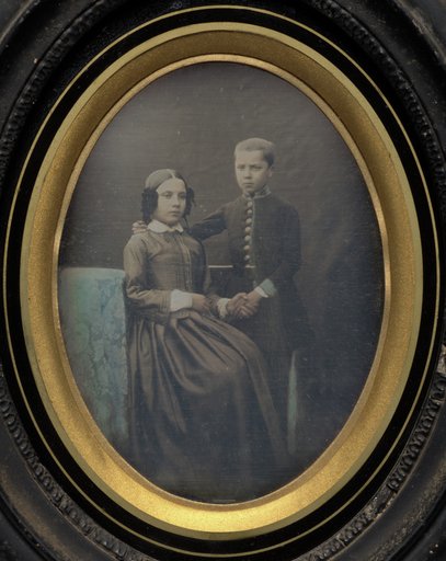 Brother and sister clasping hands
