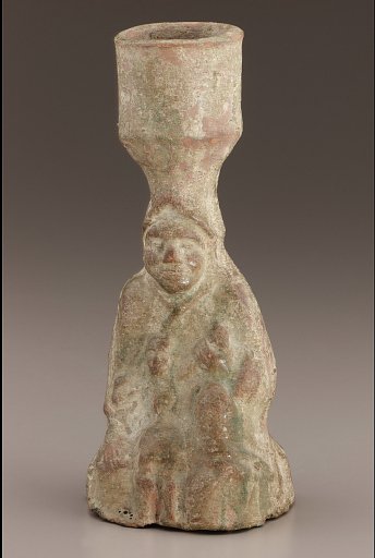 Tomb lamp in the form of a seated figure holding a child