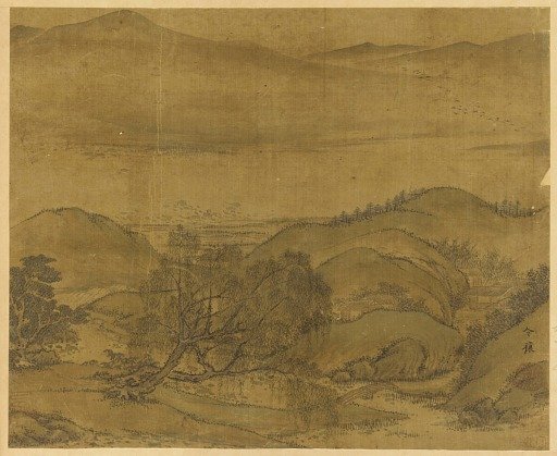 River landscape: a willow and other trees, rolling hills, and a high mountain range