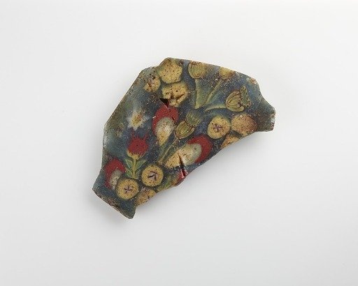 Fragment of an inlay with a floral pattern. Mended with lacquer