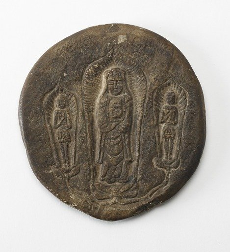 Circular plaque with Buddhist trinity on obverse and brief inscription on reverse