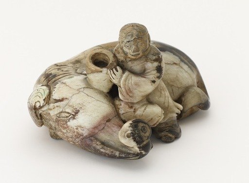 Ornament: boy with reclining elephant