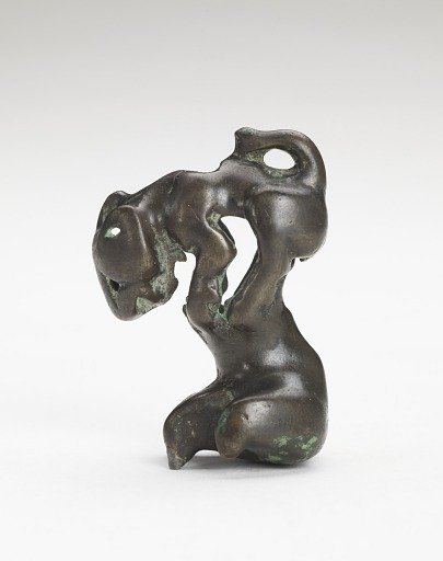 Ornament in the form of a feline-like animal on a foot-shaped stand