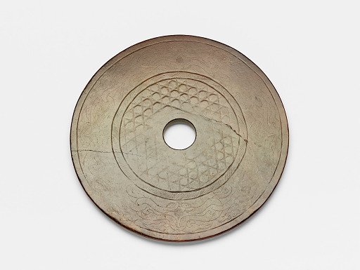 Disk (<em>bi</em>) with raised hexagons arranged in a grid and interlaced birds