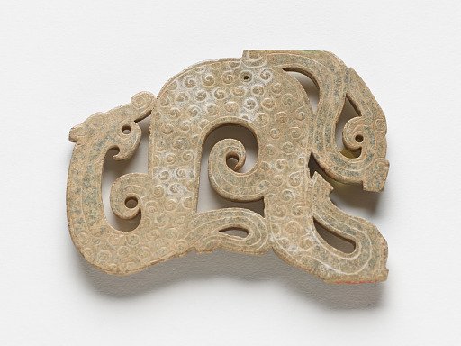 Pendant in the form of a dragon with raised uniform curls
