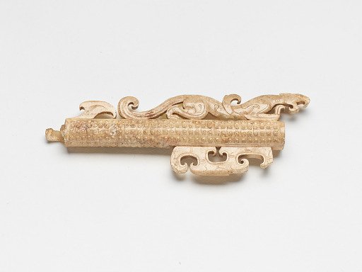 Tubular handle with feline and raised linked curls