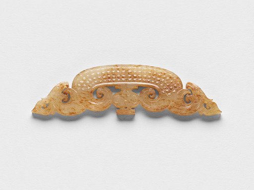 Pendant with dragon heads, vase, and raised linked curls