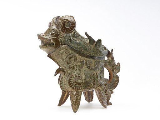 Ritual wine ewer (<em>gong</em>) with masks (<em>taotie</em>), dragons, and real animals