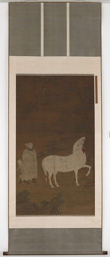 Central Asian groom pasturing a horse