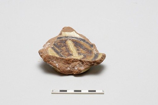 sherd, red body, white slip, yellow glaze with brown stain
