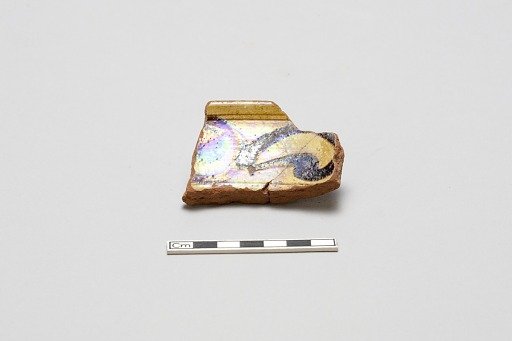 sherd, red body, white slip, yellow glaze with brown stain