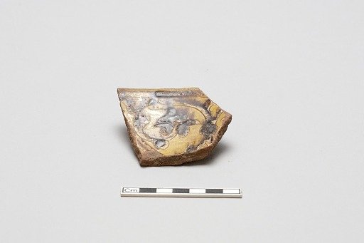 sherd, red body, white slip, yellow glaze with brown stain