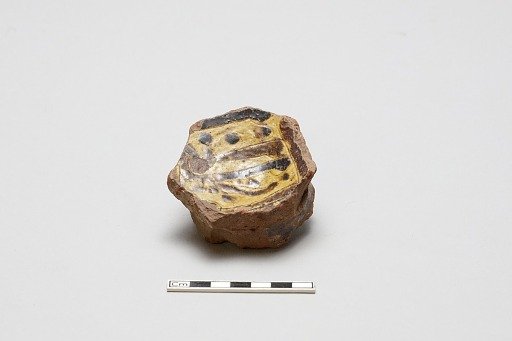 sherd, red body, white slip, yellow glaze with brown stain