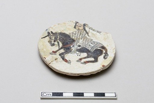 Stone-paste disk fragment of a rider