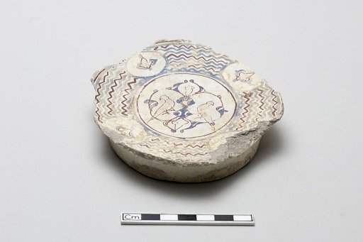 Fragmentary base of a bowl surrounded by wave design