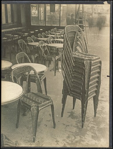 Stacked metal chairs in front of Café "Chocolat Prévost"
