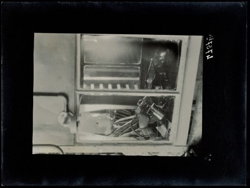 Woman standing behind a window pane with equipment