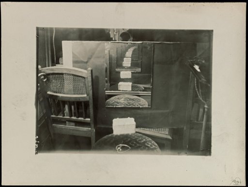 Interior with three chairs and repeated mirror reflection