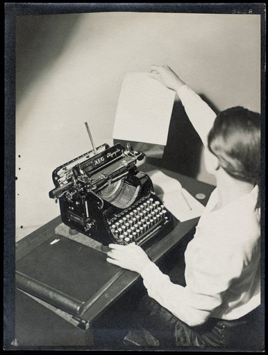Woman at an "AEG Olympia" typewriter