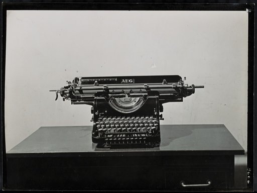 "AEG" typewriter on a small table, frontal view