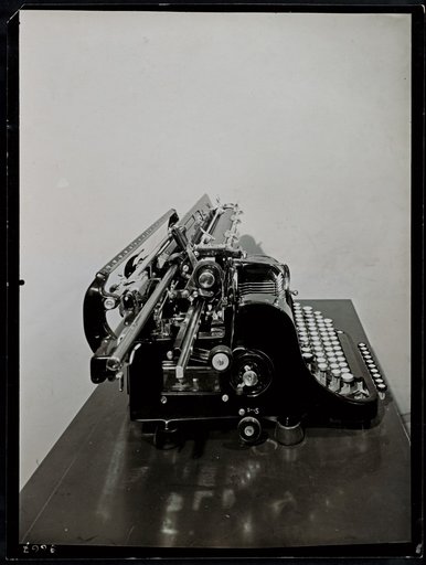 "AEG" typewriter on a small table, profile view
