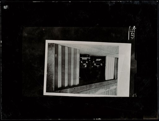 Auto Garage with Two-Part Folding Door, Advertisement for "Dauzille"