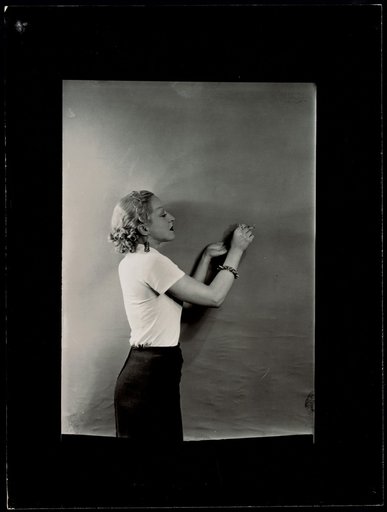 Woman posing with a matchstick between her fingers, advertisement for "Gaz et Eaux"