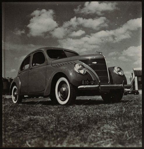 Car with Factory Building in the Background