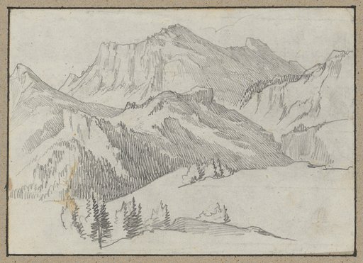 High mountain massif behind wooded foothills