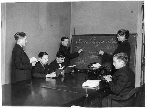 Teacher and five boys in Senate Pages' School - boy typing