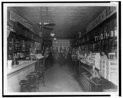 Interior of People's Drug Store, 11th and G Streets, Washington, D.C., with employees behind the counters and customers