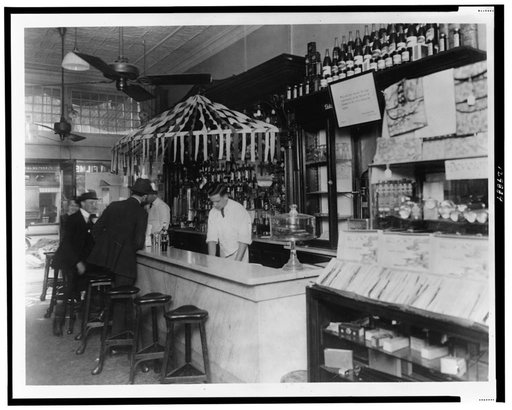 Interior of People's Drug Store, 11th and G Streets, Washington, D.C., with employees behind the counter of soda fountain and customers