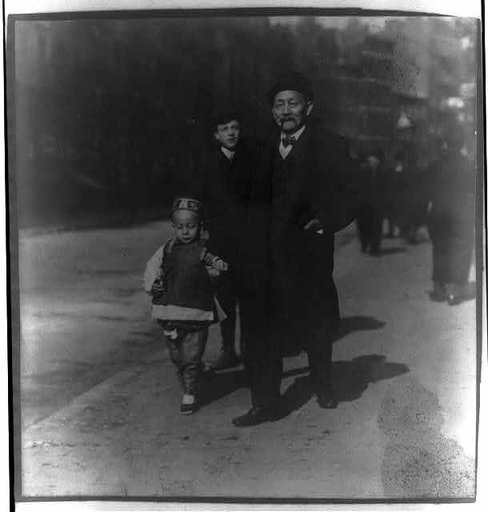 Chinese-American man walking with son, Chinatown, New York City