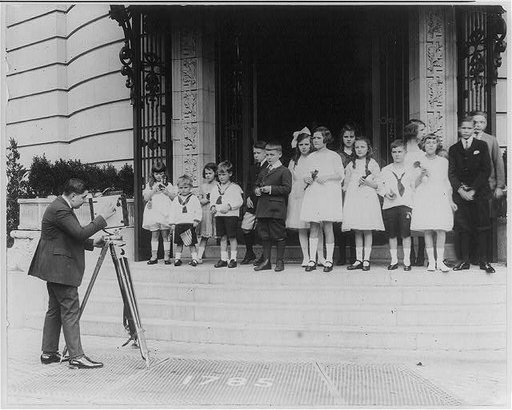 Photographer Herbert French photographing children posed at E.T. Meredith, Jr. party