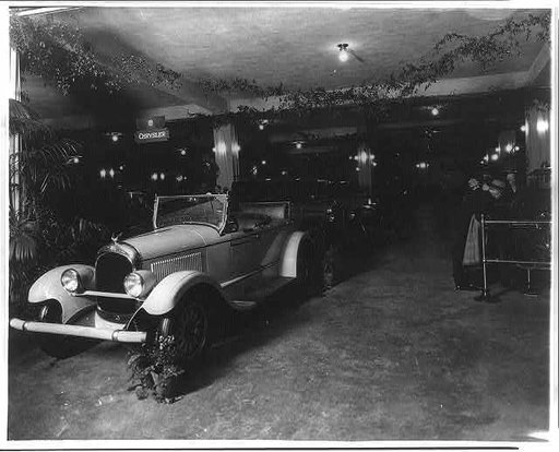 Exhibits at an unidentified auto show, probably in Washington, D.C., Chrysler convertible in foreground