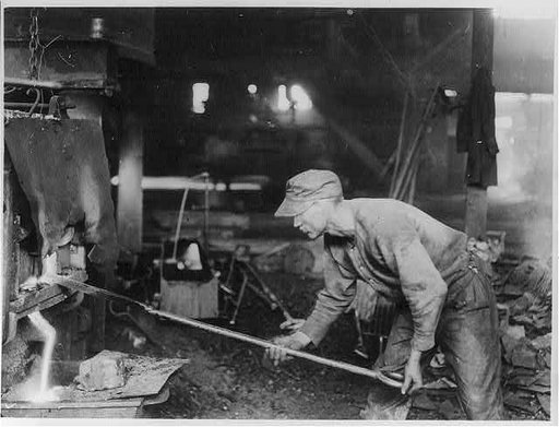 The threatening big steel strike. A view of one of the strikers who is asking for more pay, at his work of puddling, where he is "working up" his "ball of iron" to be carried to the "squeezer"