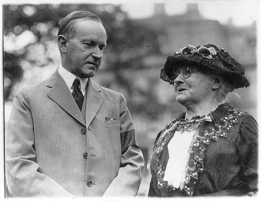 President Calvin Coolidge and "Mother" Jones, half-length, standing outdoors.