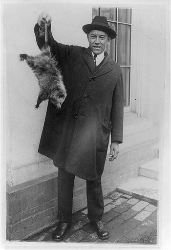Danridge Epps of Natural Bridge, Virginia, holding 6-pound opossum which was presented to Pres. Coolidge