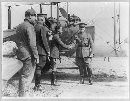 Reception of the Alaskan flyers at Washington, D.C. - Gen. Pershing congratulating Capt. Street of the squadron [alongside airplane, as 2 other men watch