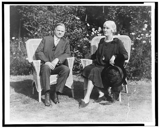 Herbert Hoover and Mrs. Hoover, full-length portrait, seated on wicker chairs, facing front