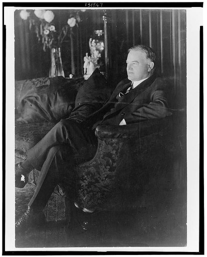 Herbert Hoover, full-length portrait, seated on sofa, facing left