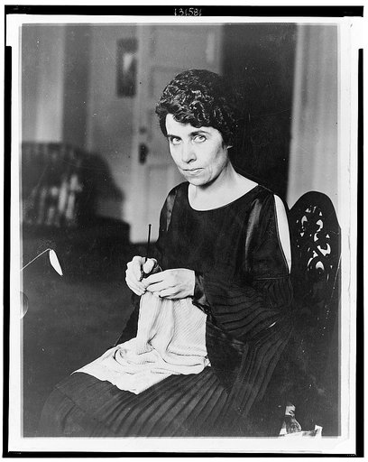 Grace Coolidge, half-length portrait, seated, knitting, facing left